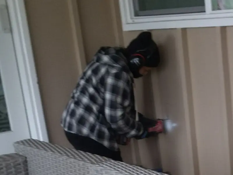 Professional electrician installing an exterior outlet in Kasson